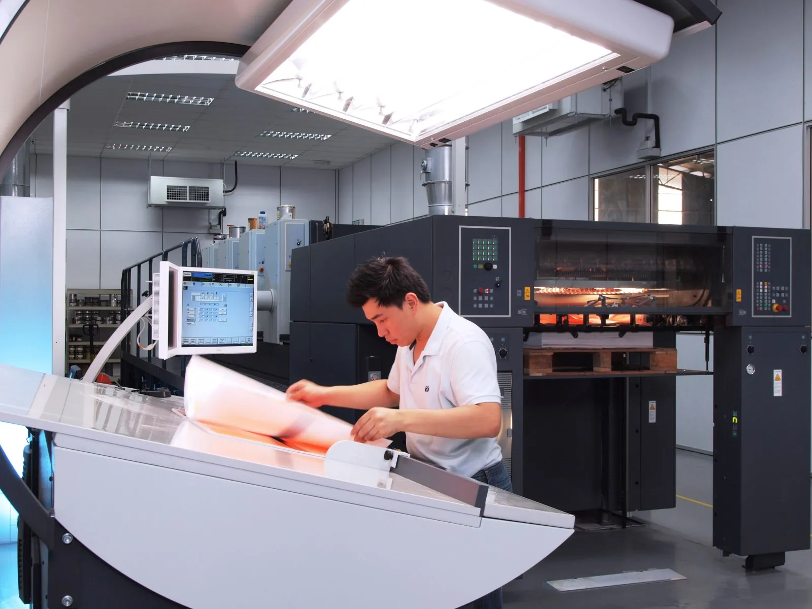 An operator at a carton printing line